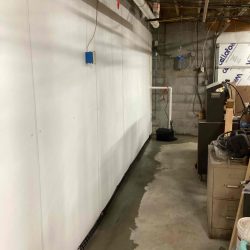 interior drainage and sump pump installed and restored along basement wall