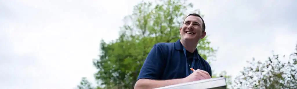 Certified Foundation Specialist smiling while reviewing an estimate