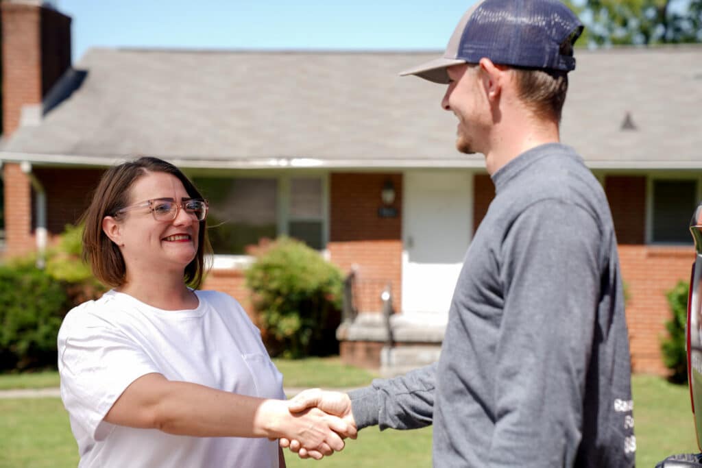 Foundation repair specialist shaking hands with a happy customer
