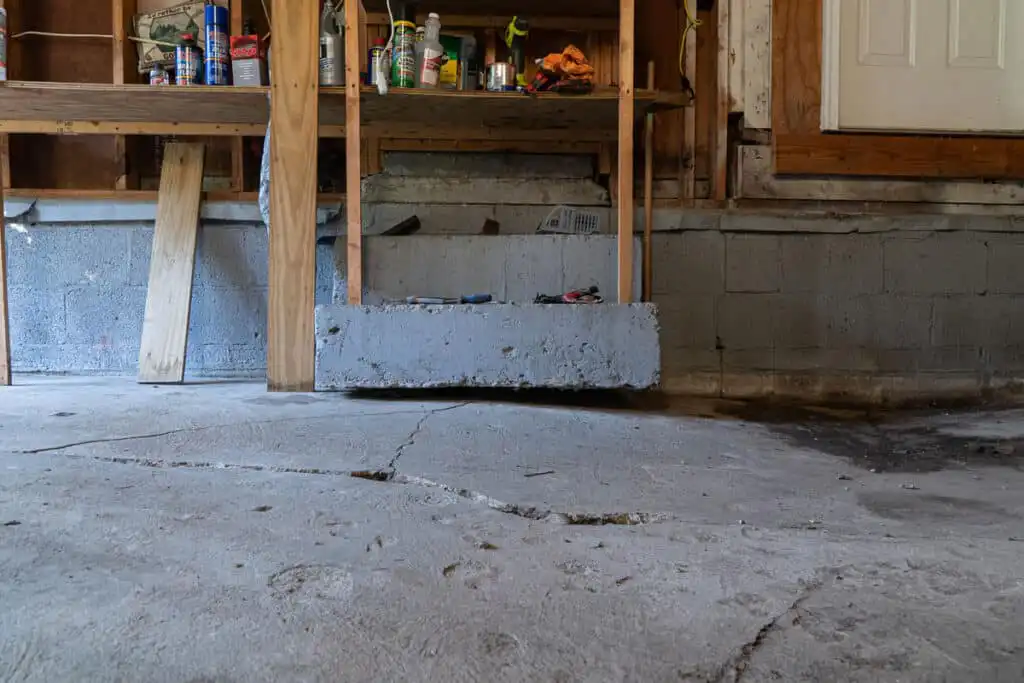 Garage with cracked concrete and inches of settling