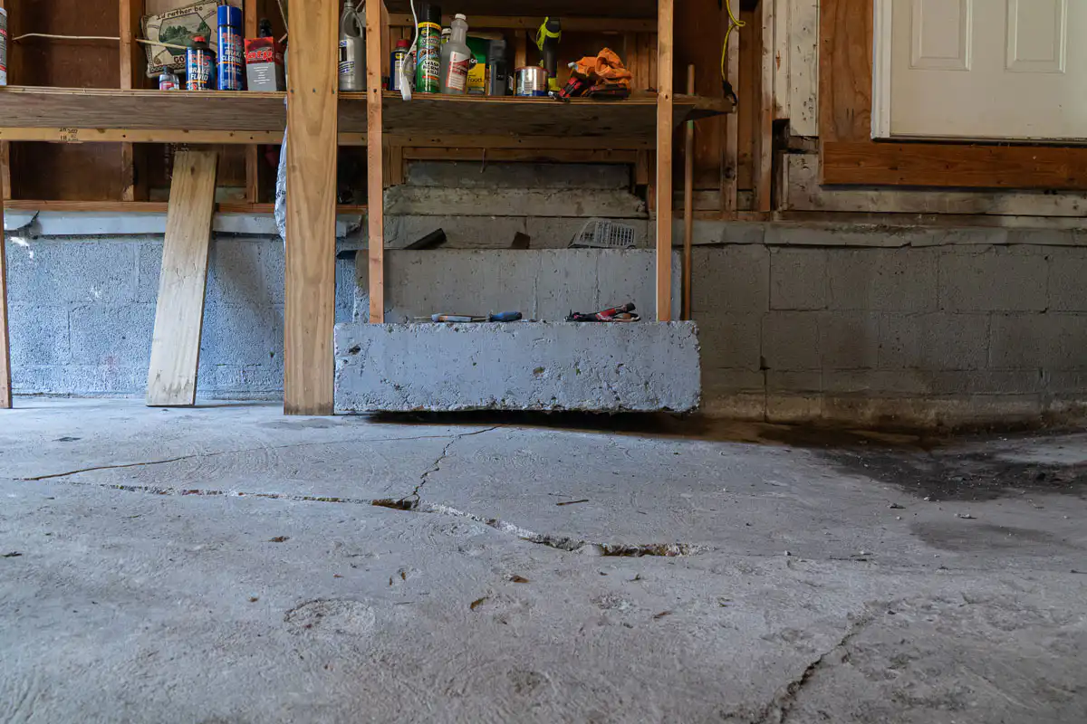 Garage with cracked concrete and inches of settling