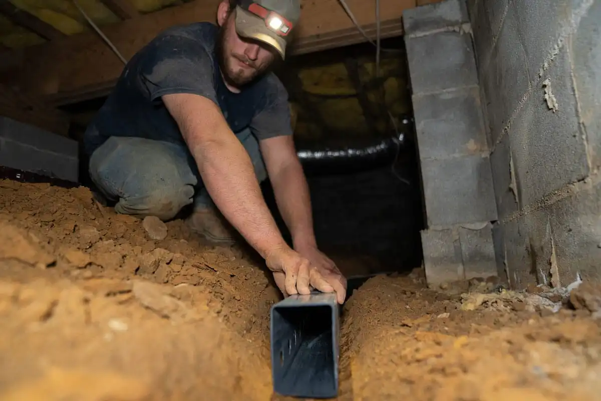 Certified Foundation Specialist installing a channel in crawl space