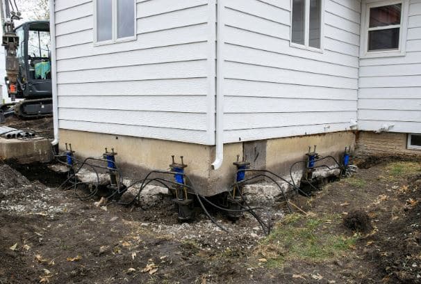 Push piers installed and visible on a home's foundation
