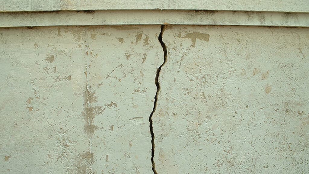 A major crack in a home's exterior foundation wall; a sign of foundation and waterproofing problems
