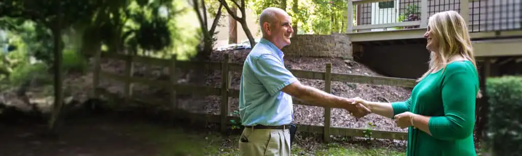 Home repair specialist and happy customer shaking hands