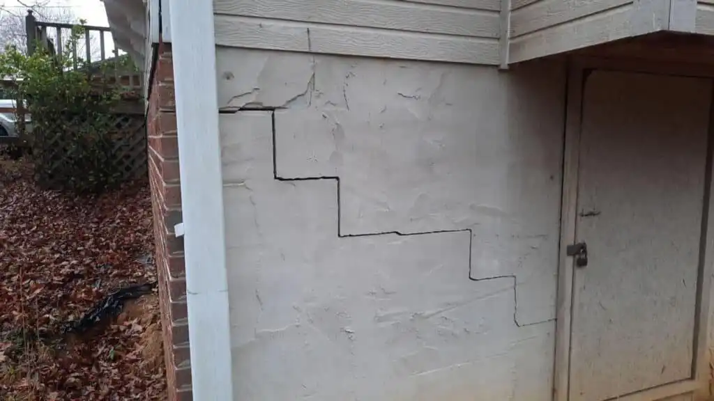 A stair-step exterior wall crack in a home's foundation