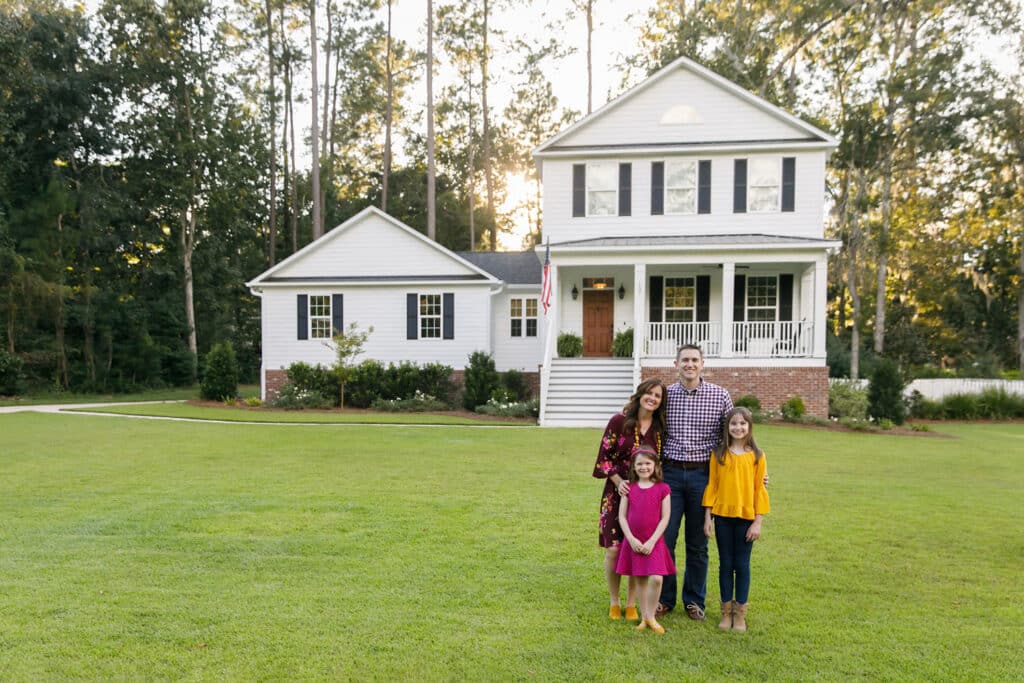 A happy family outside of a home