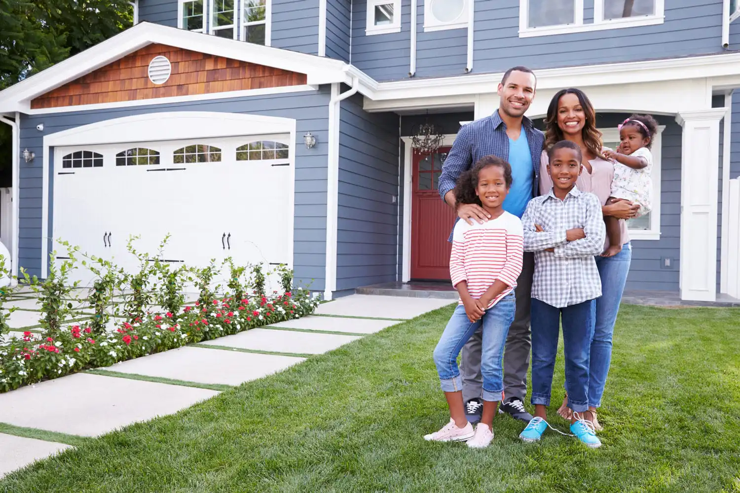 A happy family outside of a home