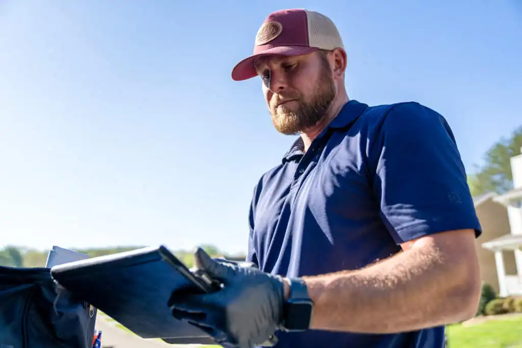Home repair specialist writing notes from a home inspection