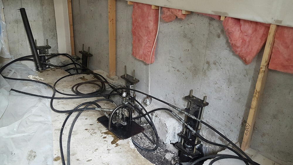 Interior installed push piers for foundation repair