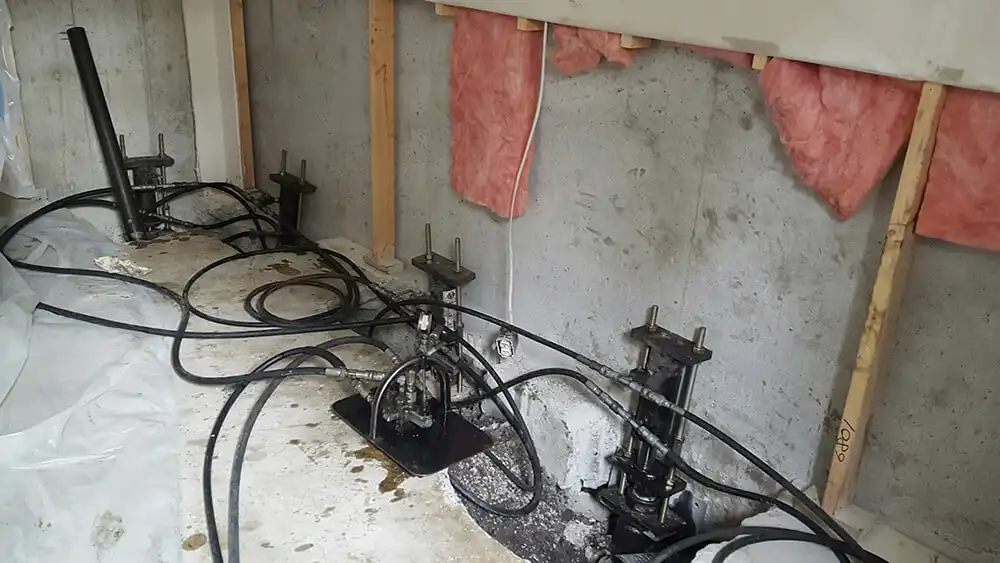 Interior installed push piers for foundation repair