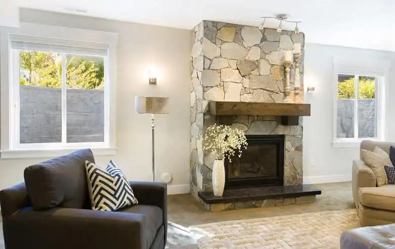 A fully finished basement living space with two egress windows visible